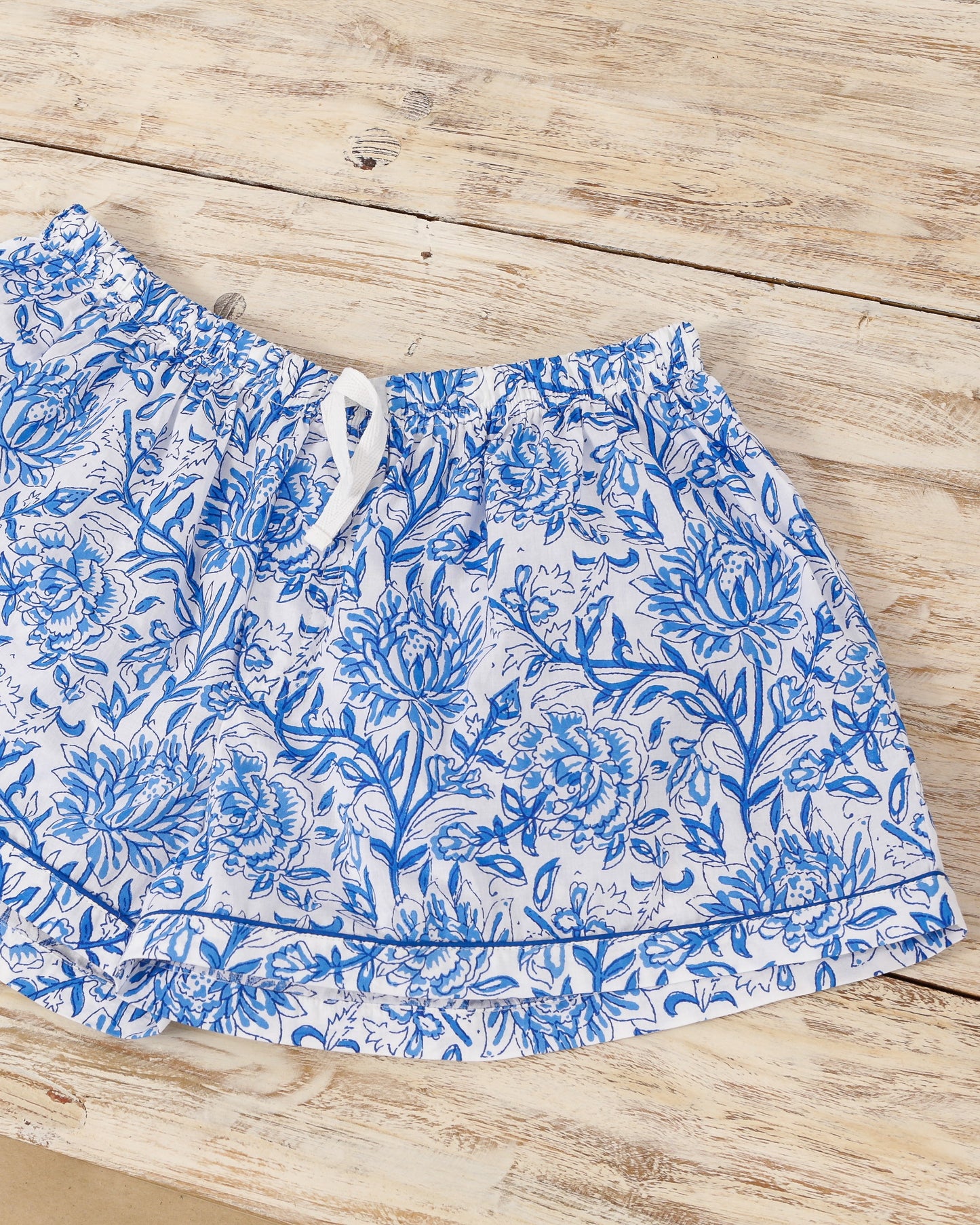 Short sleeve button-up pajama shirt and shorts set with blue floral print